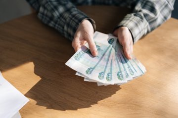 unrecognizable-female-holding-counting-stack-russian-rubles-banknotes